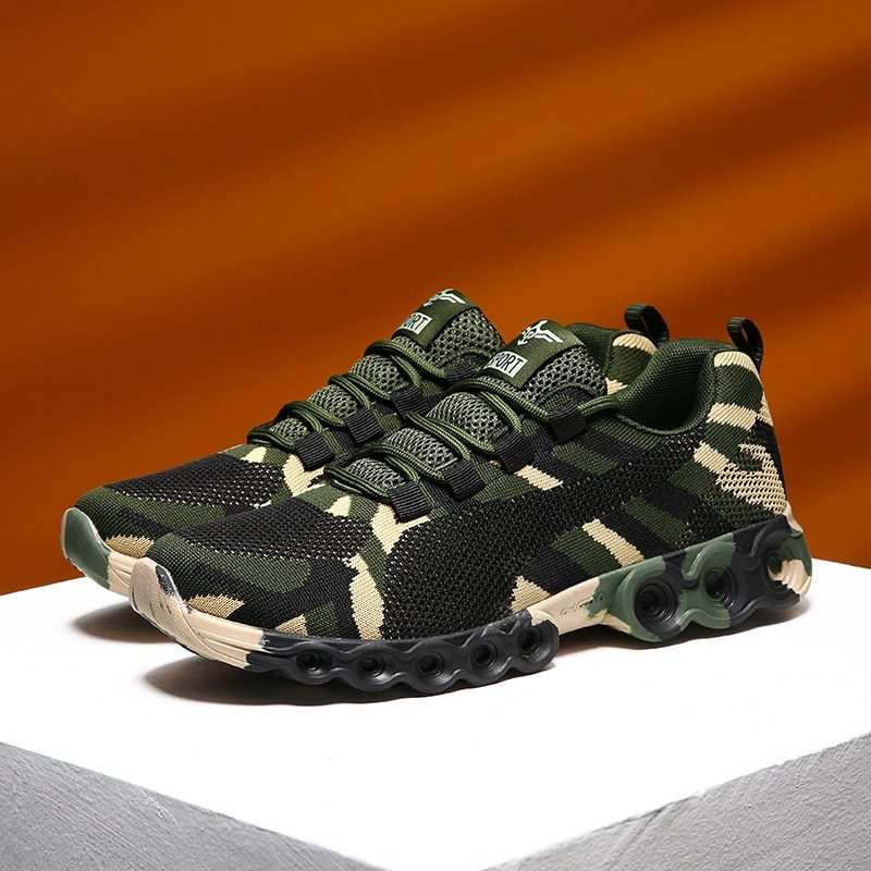 Camouflage-patterned green and black athletic shoes with breathable mesh fabric and cushioned soles.