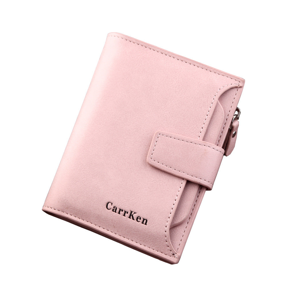 A pink leather wallet featuring a coin holder